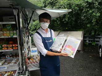 スズキヤの販売員がチラシを紹介している様子